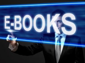 E-BOOKS - businessman touching blue screen